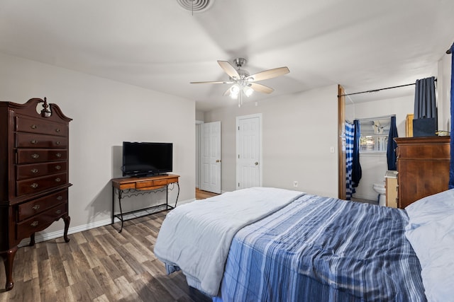 bedroom with connected bathroom, dark hardwood / wood-style floors, and ceiling fan