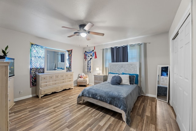 bedroom with wood-type flooring, a closet, and ceiling fan