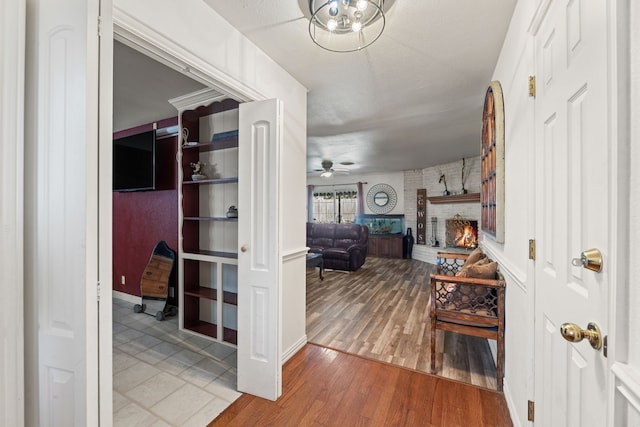 hallway with a chandelier and light hardwood / wood-style floors