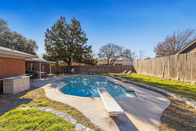 view of pool with a patio, a diving board, and area for grilling