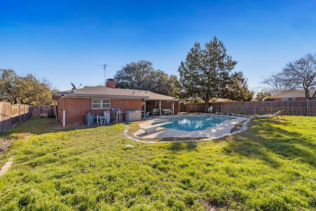 view of pool with a patio area and a lawn