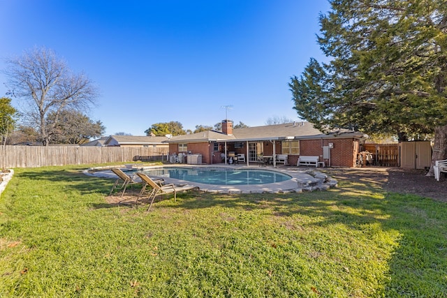 view of pool with a yard and a patio area