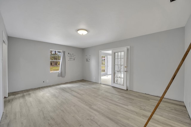 empty room with a healthy amount of sunlight and light wood-type flooring