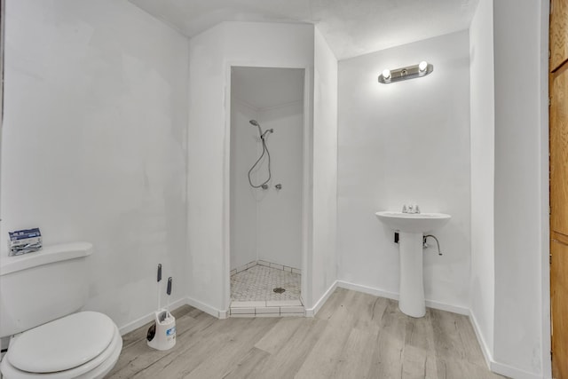 bathroom with walk in shower, wood-type flooring, and toilet