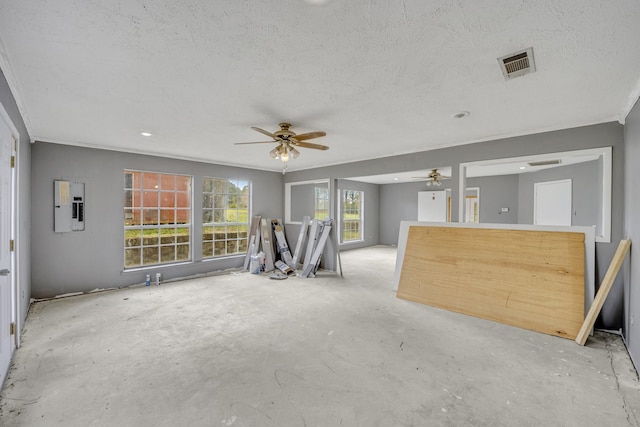 unfurnished living room with crown molding, ceiling fan, electric panel, and a textured ceiling