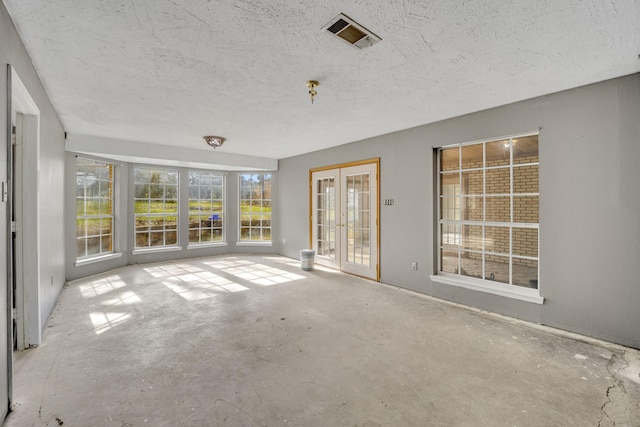 unfurnished sunroom featuring french doors