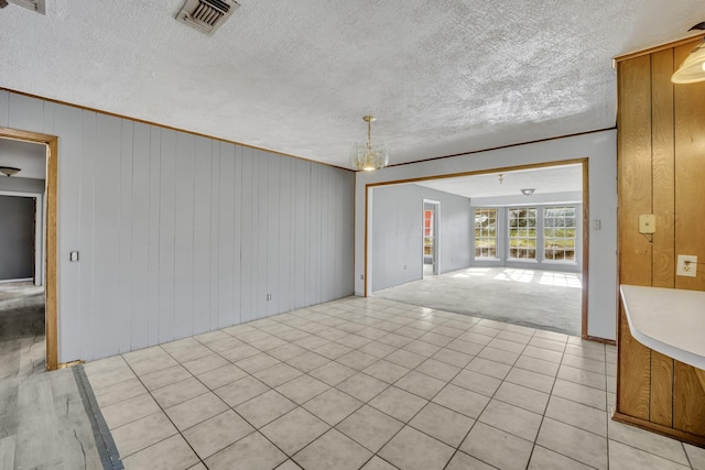 interior space with light carpet and wooden walls