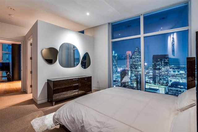 carpeted bedroom featuring floor to ceiling windows