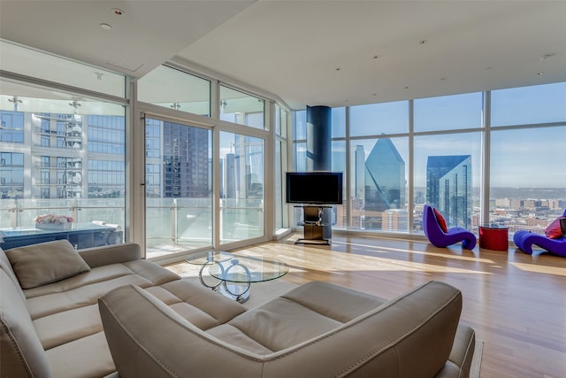 living room with expansive windows and hardwood / wood-style flooring