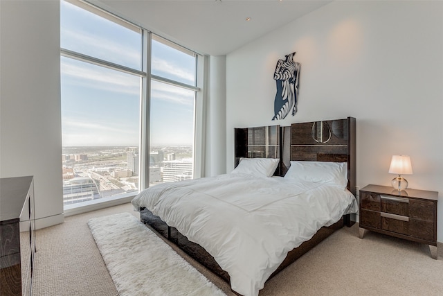 carpeted bedroom with multiple windows and floor to ceiling windows