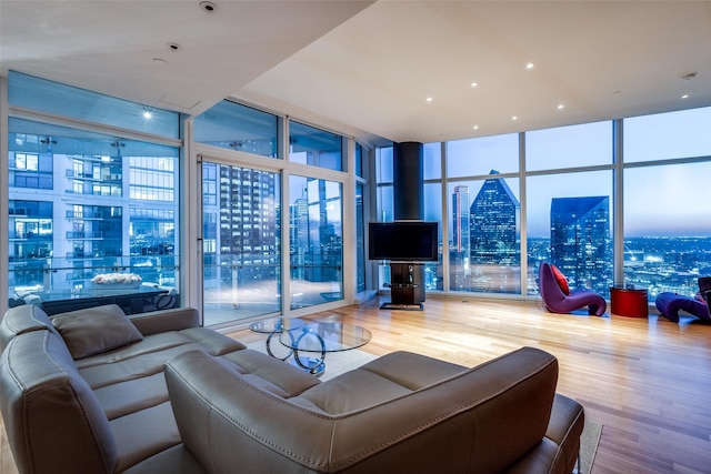 living room with hardwood / wood-style flooring and a wall of windows