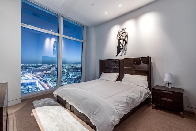 bedroom featuring a wall of windows and carpet