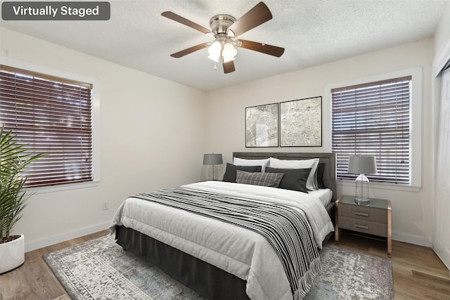 bedroom featuring hardwood / wood-style flooring and ceiling fan