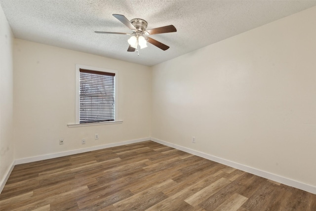 empty room featuring dark hardwood / wood-style flooring, a textured ceiling, and ceiling fan