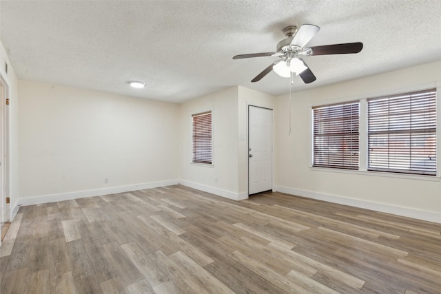 unfurnished bedroom with light wood-type flooring, a textured ceiling, and ceiling fan