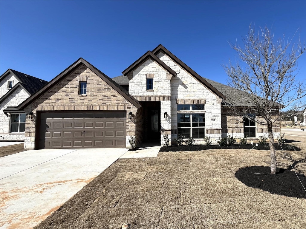 french provincial home with a garage