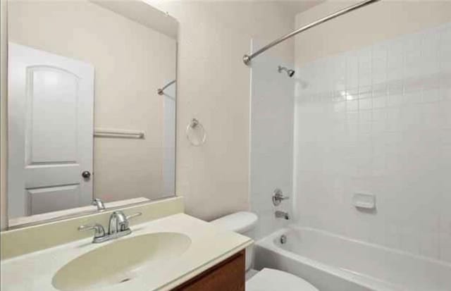 full bathroom with vanity, toilet, and  shower combination