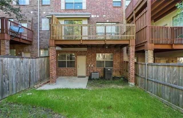 rear view of house featuring central AC, a yard, and a patio area