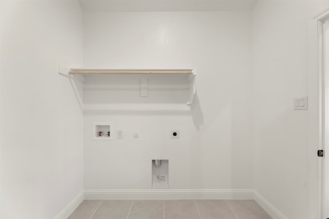 laundry area with light tile patterned floors, hookup for a gas dryer, hookup for a washing machine, and electric dryer hookup