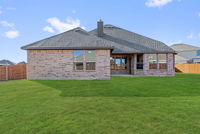 back of property with a patio and a lawn