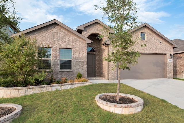 view of front of home with a garage and a front lawn