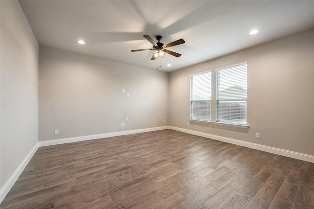 empty room with dark hardwood / wood-style floors and ceiling fan