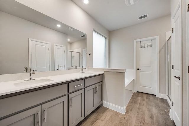 bathroom with vanity and shower with separate bathtub