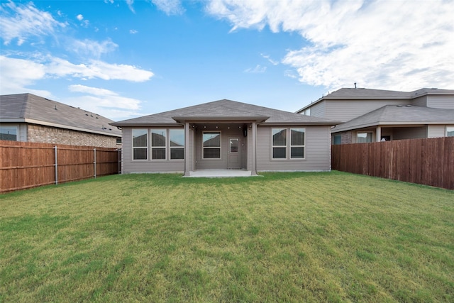 back of house featuring a yard and a patio area