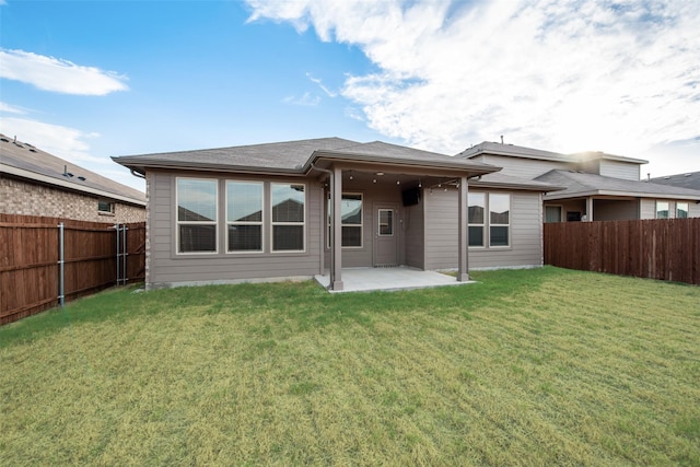 back of property featuring a patio and a yard