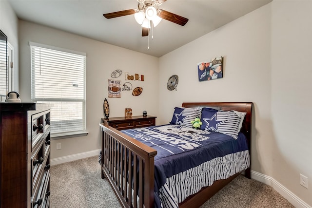 carpeted bedroom with multiple windows and ceiling fan