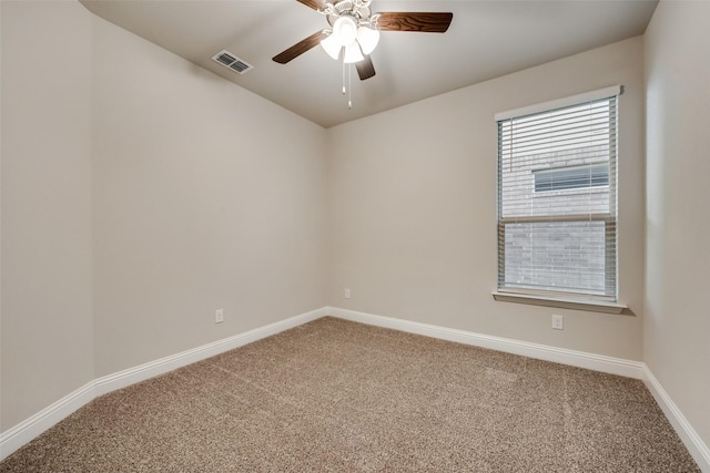 spare room featuring ceiling fan and carpet