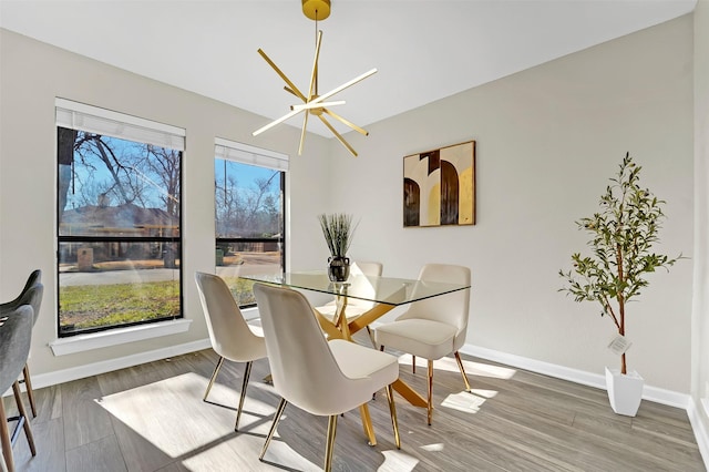 dining area with an inviting chandelier and wood-type flooring