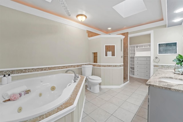 bathroom featuring a skylight, ornamental molding, vanity, toilet, and tile patterned floors