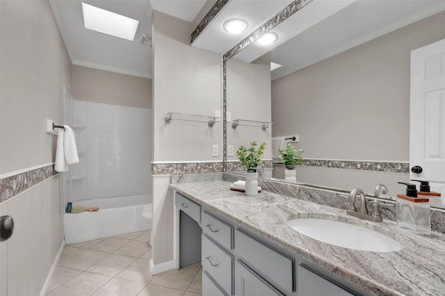 bathroom with vanity, tile patterned flooring, a skylight, and shower / bathtub combination