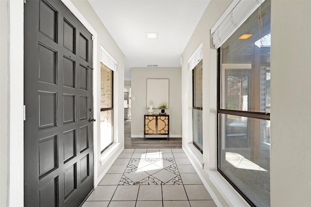 interior space with plenty of natural light and light tile patterned flooring