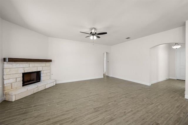 unfurnished living room featuring hardwood / wood-style flooring, a fireplace, and ceiling fan