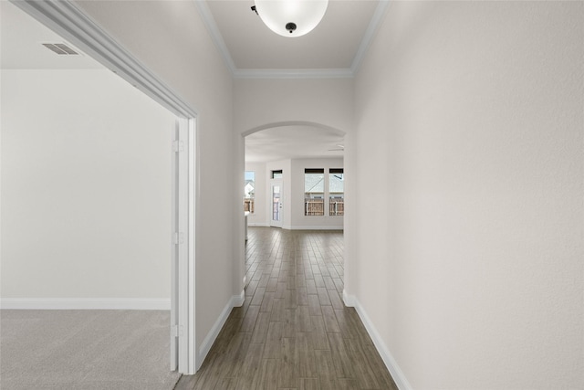 hall featuring hardwood / wood-style flooring and ornamental molding