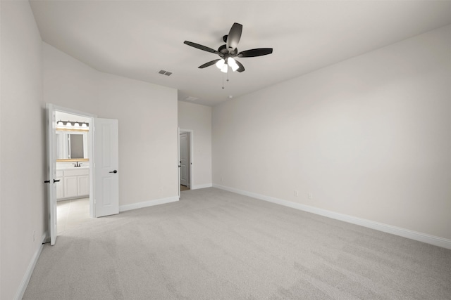 unfurnished bedroom with light carpet, sink, and ceiling fan