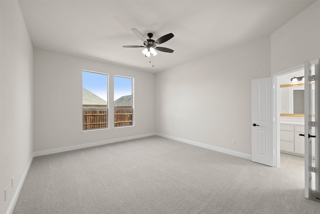 carpeted spare room with ceiling fan