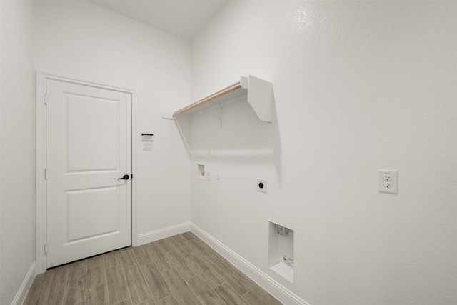 clothes washing area with electric dryer hookup, washer hookup, and light hardwood / wood-style floors