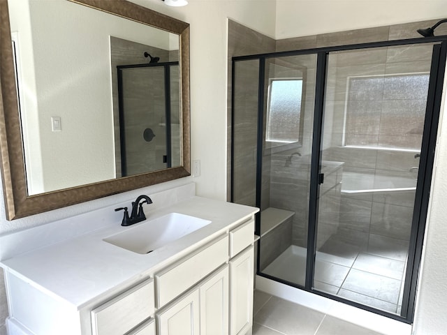 bathroom featuring vanity, a shower with door, and tile patterned floors