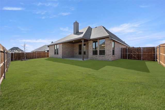 back of house featuring a patio and a yard