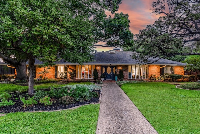 ranch-style house featuring a lawn