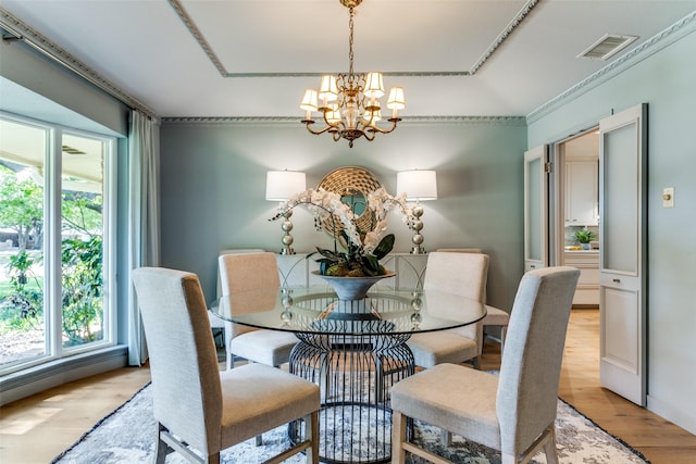 dining space with a chandelier and light hardwood / wood-style floors