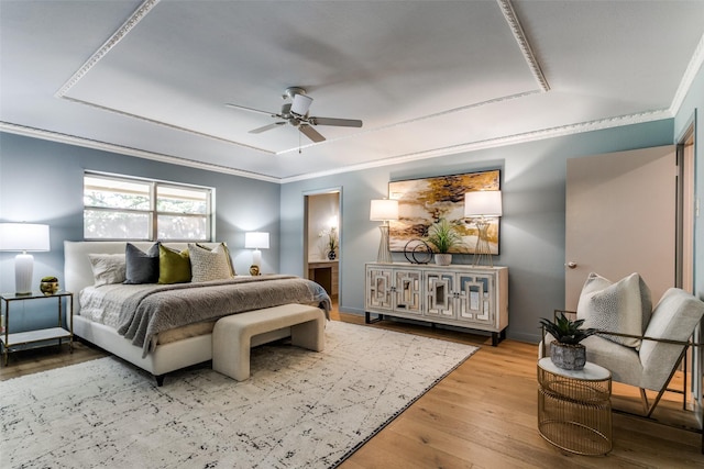 bedroom featuring crown molding, ceiling fan, and light hardwood / wood-style floors