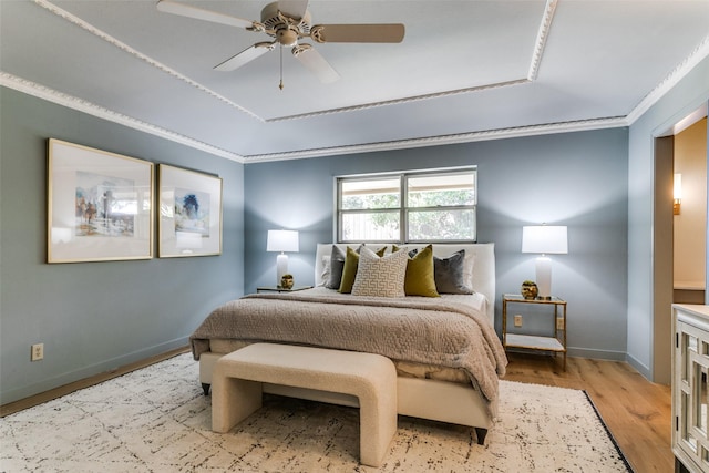 bedroom with crown molding, ceiling fan, and light hardwood / wood-style floors