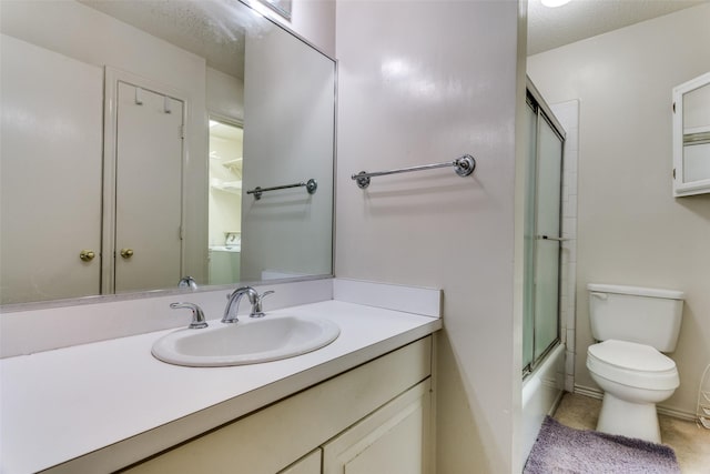 full bathroom featuring vanity, a textured ceiling, bath / shower combo with glass door, and toilet