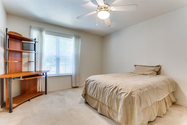 bedroom with ceiling fan and light colored carpet