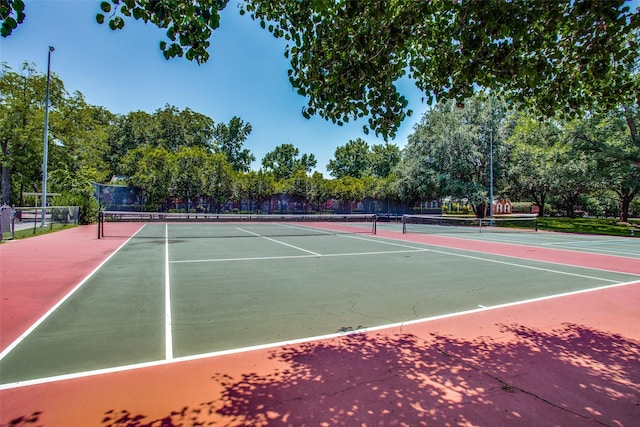 view of tennis court with basketball hoop