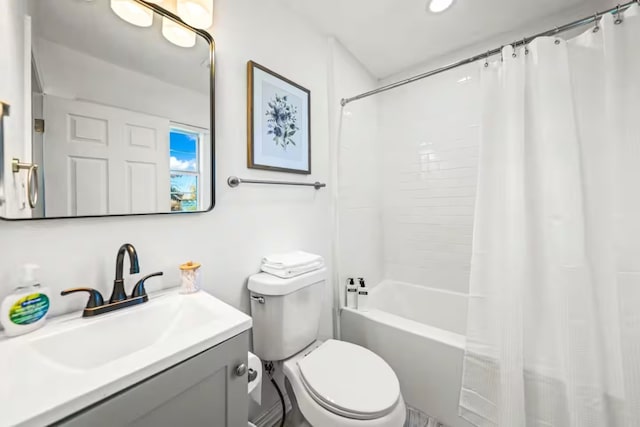 bathroom with toilet, shower / bath combo, and vanity